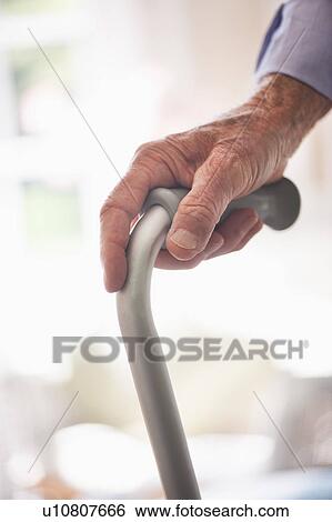 Wrinkled hand holding walking stick View Large Photo Image Stock Photograph - Wrinkled hand holding walking stick. Fotosearch