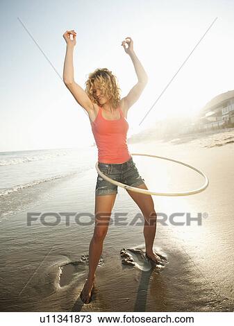 Young attractive woman exercising with hoola hoop View Large Photo Image Stock Image - Young attractive woman exercising with hoola hoop. Fotosearch