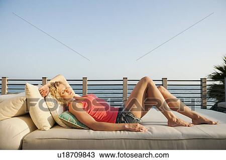 Stock Image - Young attractive woman sunbathing. Fotosearch