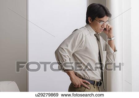 Young businessman using cell phone View Large Photo Image Stock Photo - Young businessman using cell phone. Fotosearch