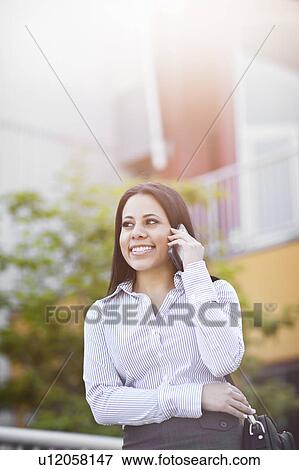 Stock Photo - Young businesswoman talking on phone. Fotosearch