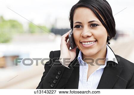 Young businesswoman talking on phone View Large Photo Image Stock Photo - Young businesswoman talking on phone. Fotosearch