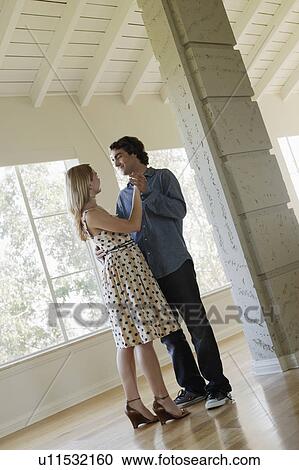 Young couple dancing in empty room View Large Photo Image Stock Image - Young couple dancing in empty room. Fotosearch