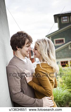 Young couple embracing, face to face View Large Photo Image Stock Image - Young couple embracing, face to face. Fotosearch