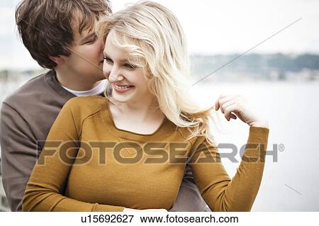 Young couple embracing on pier View Large Photo Image Stock Photo - Young couple embracing on pier. Fotosearch