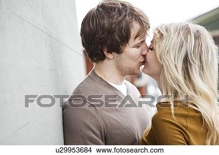 Picture - Young couple kissing. Fotosearch