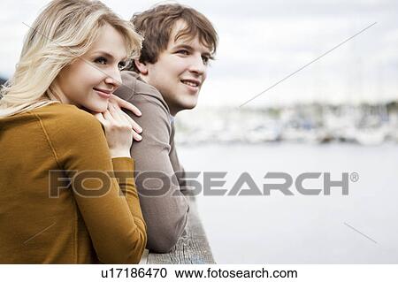 Young couple on pier View Large Photo Image Stock Image - Young couple on pier. Fotosearch