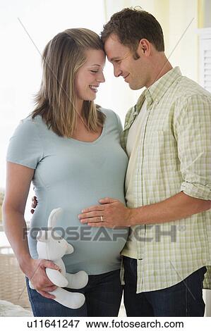 Young couple standing in nursery View Large Photo Image Stock Photo - Young couple standing in nursery. Fotosearch