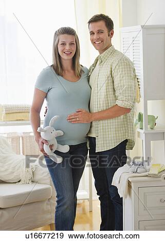 Young couple standing in nursery View Large Photo Image Stock Photo - Young couple standing in nursery. Fotosearch