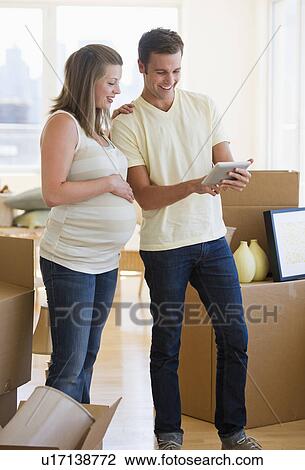 Young couple unpacking View Large Photo Image Stock Image - Young couple unpacking. Fotosearch