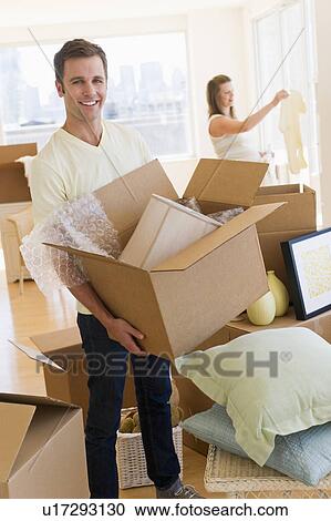 Young couple unpacking View Large Photo Image Stock Image - Young couple unpacking. Fotosearch