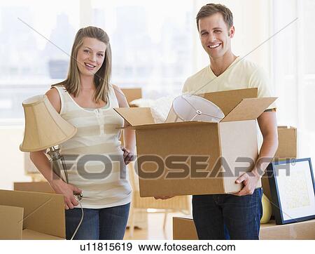 Young couple unpacking View Large Photo Image Stock Photo - Young couple unpacking. Fotosearch