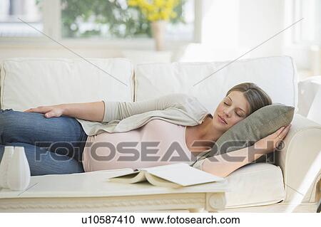 Young pregnant woman sleeping on sofa View Large Photo Image Stock Image - Young pregnant woman sleeping on sofa. Fotosearch