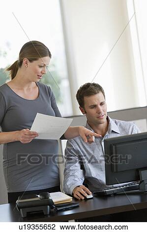Young pregnant woman working with colleague in office View Large Photo Image Stock Image - Young pregnant woman working with colleague in office. Fotosearch