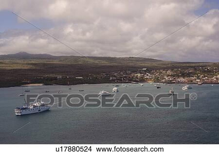Boats in the ocean with coastal town in the background, Puerto Baquerizo Moreno, San Cristobal Island, Galapagos Islands, Ecuador View Large Photo Image Picture - Boats in the ocean with coastal town in the background, Puerto Baquerizo Moreno, San Cristobal Island, Galapagos Islands, Ecuador. Fotosearch