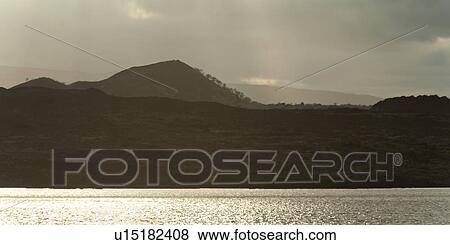 Stock Photo - Clouds over mountains, Santiago Island, Galapagos Islands, Ecuador. Fotosearch