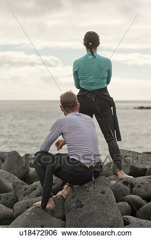 Couple on the coast, Puerto Baquerizo Moreno, San Cristobal Island, Galapagos Islands, Ecuador View Large Photo Image Stock Photograph - Couple on the coast, Puerto Baquerizo Moreno, San Cristobal Island, Galapagos Islands, Ecuador. Fotosearch
