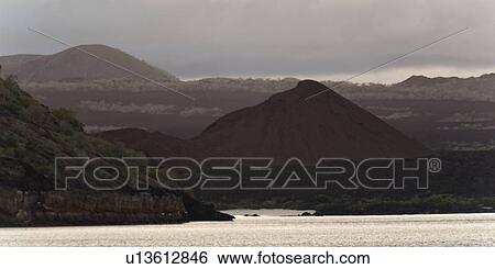Stock Photograph - Pacific Ocean with mountain range in the background, Santiago Island, Galapagos Islands, Ecuador. Fotosearch