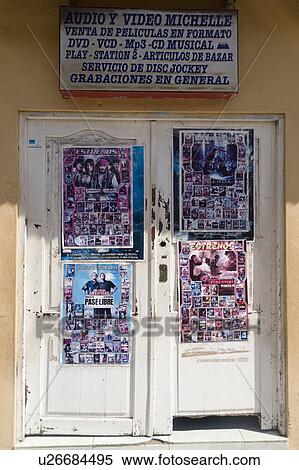 Stock Photography - Posters on the door of a music store, Puerto Baquerizo Moreno, San Cristobal Island, Galapagos Islands, Ecuador. Fotosearch