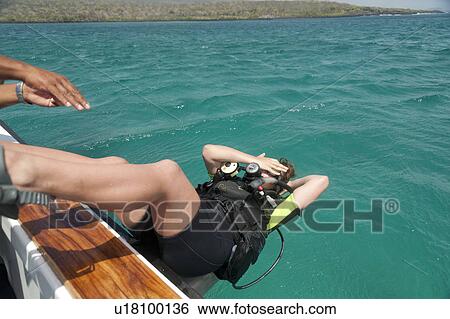 Scuba diver diving into the Pacific Ocean, San Cristobal Island, Galapagos Islands, Ecuador View Large Photo Image Stock Photograph - Scuba diver diving into the Pacific Ocean, San Cristobal Island, Galapagos Islands, Ecuador. Fotosearch