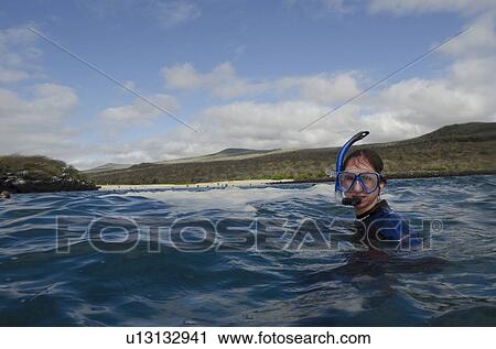 Stock Image - Scuba diver diving underwater, Playa Ochoa, San Cristobal Island, Galapagos Islands, Ecuador. Fotosearch