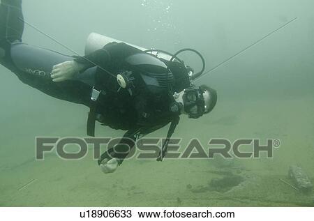 Scuba diver investigating shipwreck, San Cristobal Island, Galapagos Islands, Ecuador View Large Photo Image Stock Image - Scuba diver investigating shipwreck, San Cristobal Island, Galapagos Islands, Ecuador. Fotosearch
