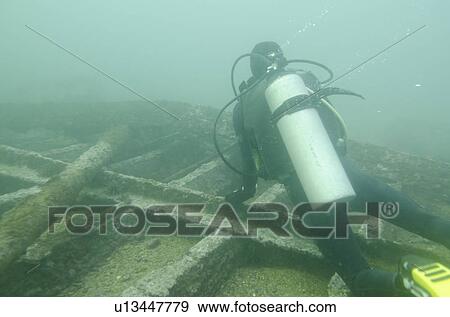 Scuba diver investigating shipwreck, San Cristobal Island, Galapagos Islands, Ecuador View Large Photo Image Stock Photo - Scuba diver investigating shipwreck, San Cristobal Island, Galapagos Islands, Ecuador. Fotosearch
