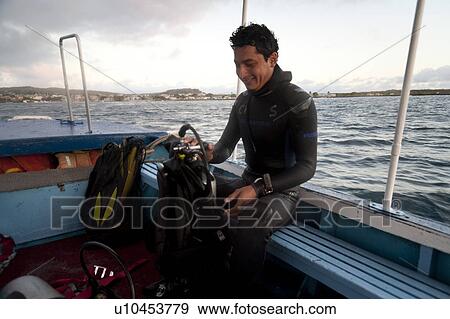 Scuba diver preparing for a dive, Puerto Baquerizo Moreno, San Cristobal Island, Galapagos Islands, Ecuador View Large Photo Image Stock Photo - Scuba diver preparing for a dive, Puerto Baquerizo Moreno, San Cristobal Island, Galapagos Islands, Ecuador. Fotosearch