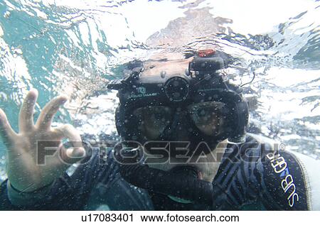 Scuba diver showing Ok sign underwater, San Cristobal Island, Galapagos Islands, Ecuador View Large Photo Image Stock Image - Scuba diver showing Ok sign underwater, San Cristobal Island, Galapagos Islands, Ecuador. Fotosearch