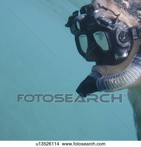 Picture - Scuba diver swimming underwater, Puerto Egas, Santiago Island, Galapagos Islands, Ecuador. Fotosearch
