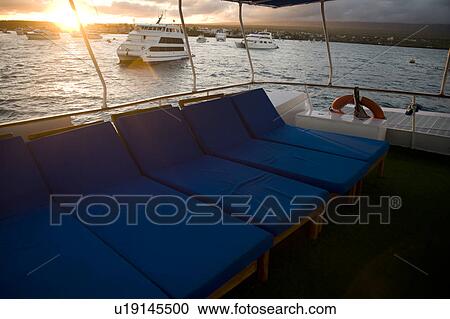 Stock Image - Ship in an ocean at dusk, Puerto Ayora, Santa Cruz Island, Galapagos Islands, Ecuador. Fotosearch