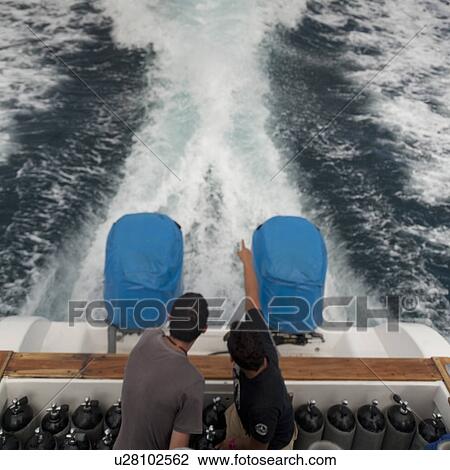 Stock Image - Tourists in boats, San Cristobal Island, Galapagos Islands, Ecuador. Fotosearch