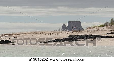 Tourists on the beach with Kicker Rock in the background, San Cristobal Island, Galapagos Islands, Ecuador View Large Photo Image Stock Image - Tourists on the beach with Kicker Rock in the background, San Cristobal Island, Galapagos Islands, Ecuador. Fotosearch