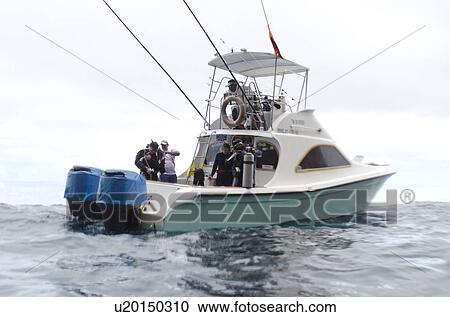 Tourists preparing for scuba diving, San Cristobal Island, Galapagos Islands, Ecuador View Large Photo Image Stock Image - Tourists preparing for scuba diving, San Cristobal Island, Galapagos Islands, Ecuador. Fotosearch