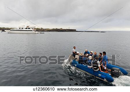 Tourists sitting in a panga boat, Puerto Egas, Santiago island, Galapagos Islands, Ecuador View Large Photo Image Stock Image - Tourists sitting in a panga boat, Puerto Egas, Santiago island, Galapagos Islands, Ecuador. Fotosearch