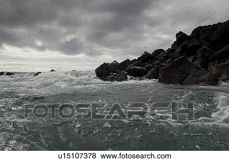 Stock Photo - Waves breaking on the coast, Playa Ochoa, San Cristobal Island, Galapagos Islands, Ecuador. Fotosearch
