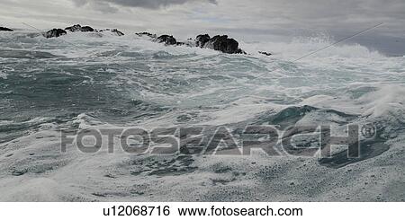 Stock Photograph - Waves breaking on the coast, Playa Ochoa, San Cristobal Island, Galapagos Islands, Ecuador. Fotosearch
