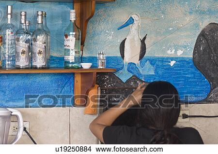 Picture - Woman at a restaurant, Puerto Baquerizo Moreno, San Cristobal Island, Galapagos Islands, Ecuador. Fotosearch