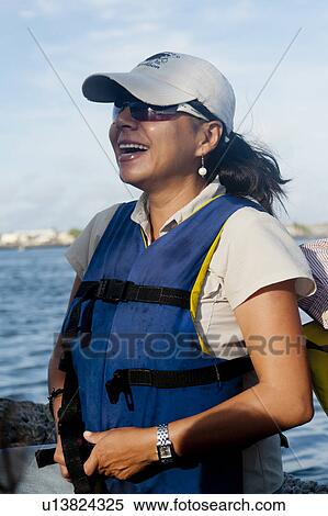 Stock Photography - Woman laughing, Puerto Baquerizo Moreno, San Cristobal Island, Galapagos Islands, Ecuador. Fotosearch