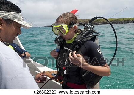 Woman preparing for scuba diving, San Cristobal Island, Galapagos Islands, Ecuador View Large Photo Image Stock Image - Woman preparing for scuba diving, San Cristobal Island, Galapagos Islands, Ecuador. Fotosearch