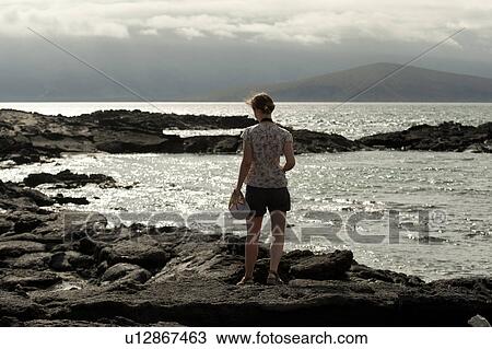 Woman standing on the beach, Punta Espinoza, Fernandina Island, Galapagos Islands, Ecuador View Large Photo Image Stock Image - Woman standing on the beach, Punta Espinoza, Fernandina Island, Galapagos Islands, Ecuador. Fotosearch