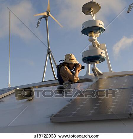 Woman taking picture with a digital camera from a yacht, Punta Suarez, Espanola Island, Hood Island, Galapagos Islands, Ecuador View Large Photo Image Stock Photo - Woman taking picture with a digital camera from a yacht, Punta Suarez, Espanola Island, Hood Island, Galapagos Islands, Ecuador. Fotosearch