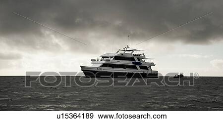 Yacht in the Pacific Ocean, San Cristobal Island, Galapagos Islands, Ecuador View Large Photo Image Stock Photo - Yacht in the Pacific Ocean, San Cristobal Island, Galapagos Islands, Ecuador. Fotosearch