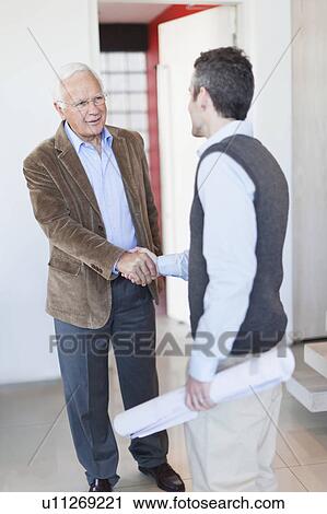 Architects shaking hands in office View Large Photo Image Stock Image - Architects shaking hands in office. Fotosearch