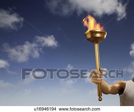 Athlete holding flaming baton View Large Photo Image Picture - Athlete holding flaming baton. Fotosearch