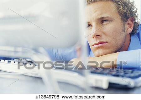 Bored businessman resting on desk View Large Photo Image Stock Photo - Bored businessman resting on desk. Fotosearch