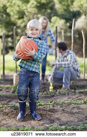 Boy carrying gourd in garden View Large Photo Image Stock Image - Boy carrying gourd in garden. Fotosearch