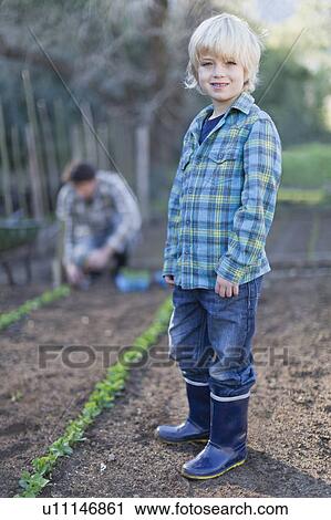 Boy gardening with father View Large Photo Image Stock Image - Boy gardening with father. Fotosearch