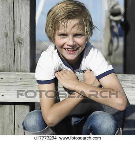 Boy smiling on pier View Large Photo Image Picture - Boy smiling on pier. Fotosearch