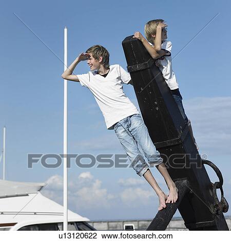 Boys climbing on pier View Large Photo Image Stock Image - Boys climbing on pier. Fotosearch